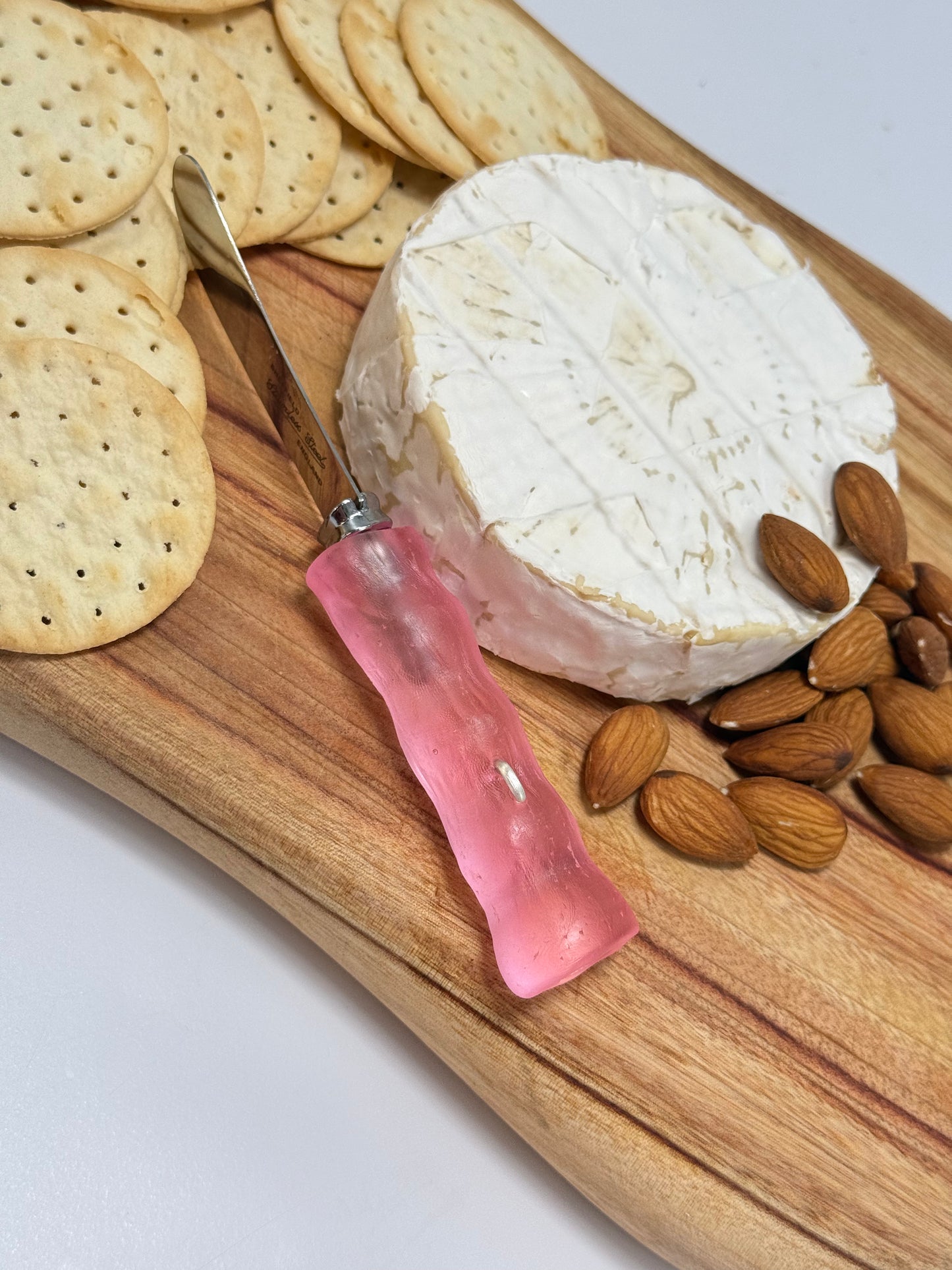 Cheese knife - Pale pink resin - irregular shaped handle with silver staple insert