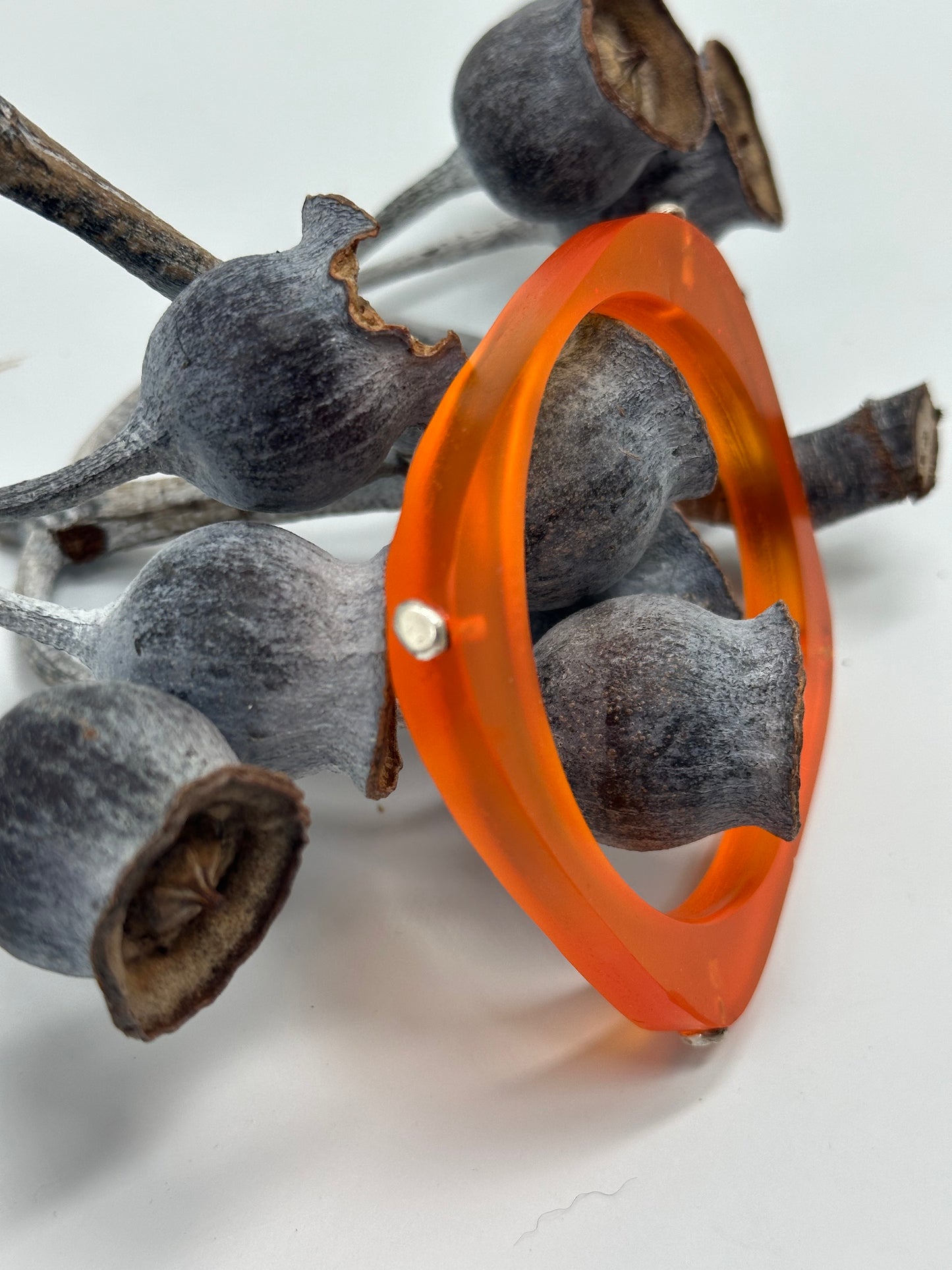 Orange 'square round' bangle with silver