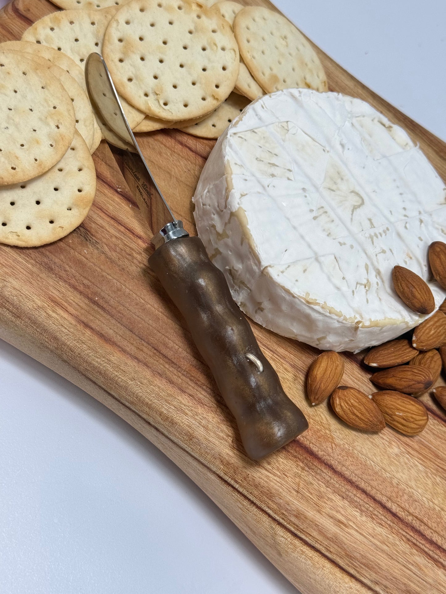 Cheese knife - Brown/bronze resin - irregular shaped handle with silver staple insert