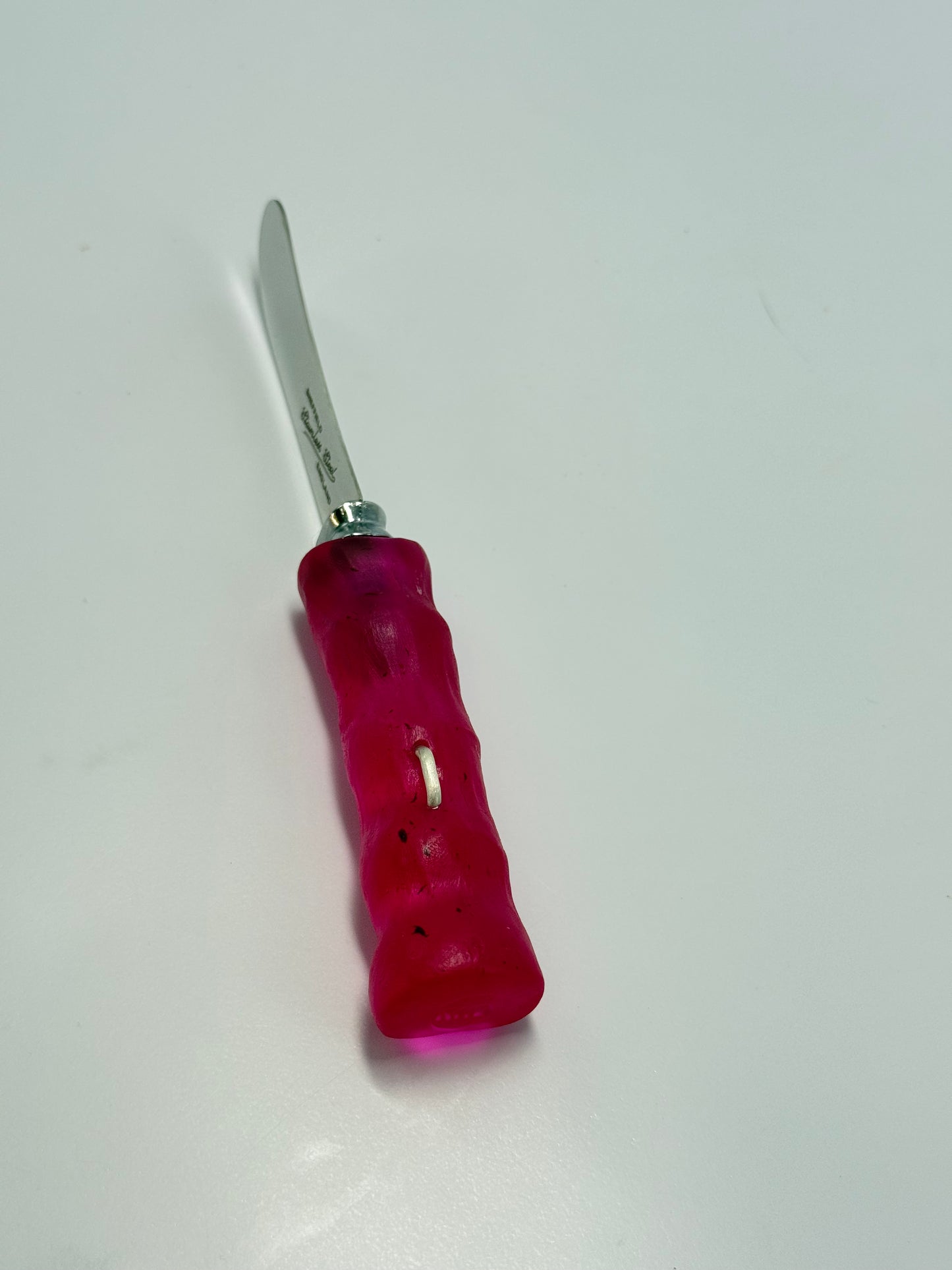 Cheese knife - Strawberry Red resin - irregular shaped handle with silver staple insert