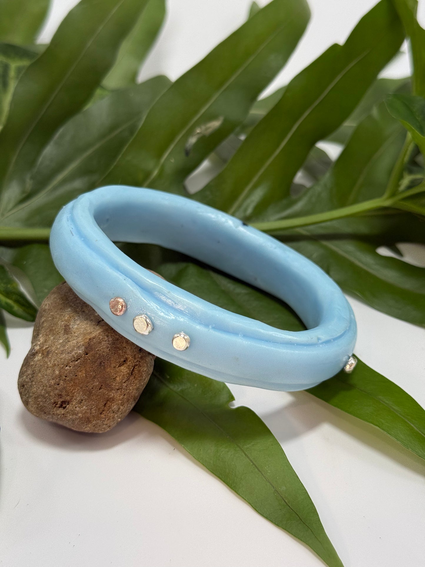 Baby blue coloured resin rim bangle with sterling silver rivets