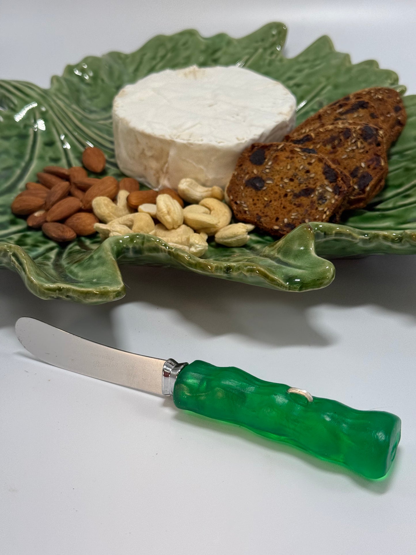 Cheese knife - Translucent Jade green with white specs resin - irregular shaped handle with silver staple insert