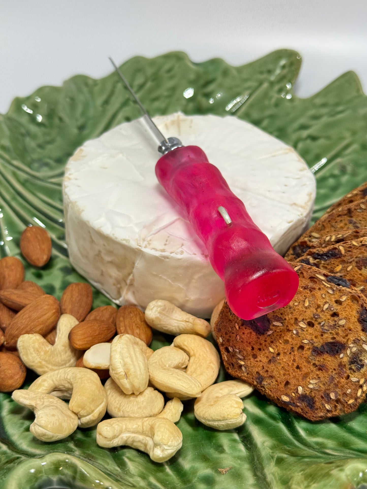 Cheese knife - Translucent Pink/red with white specs resin - irregular shaped handle with silver staple insert