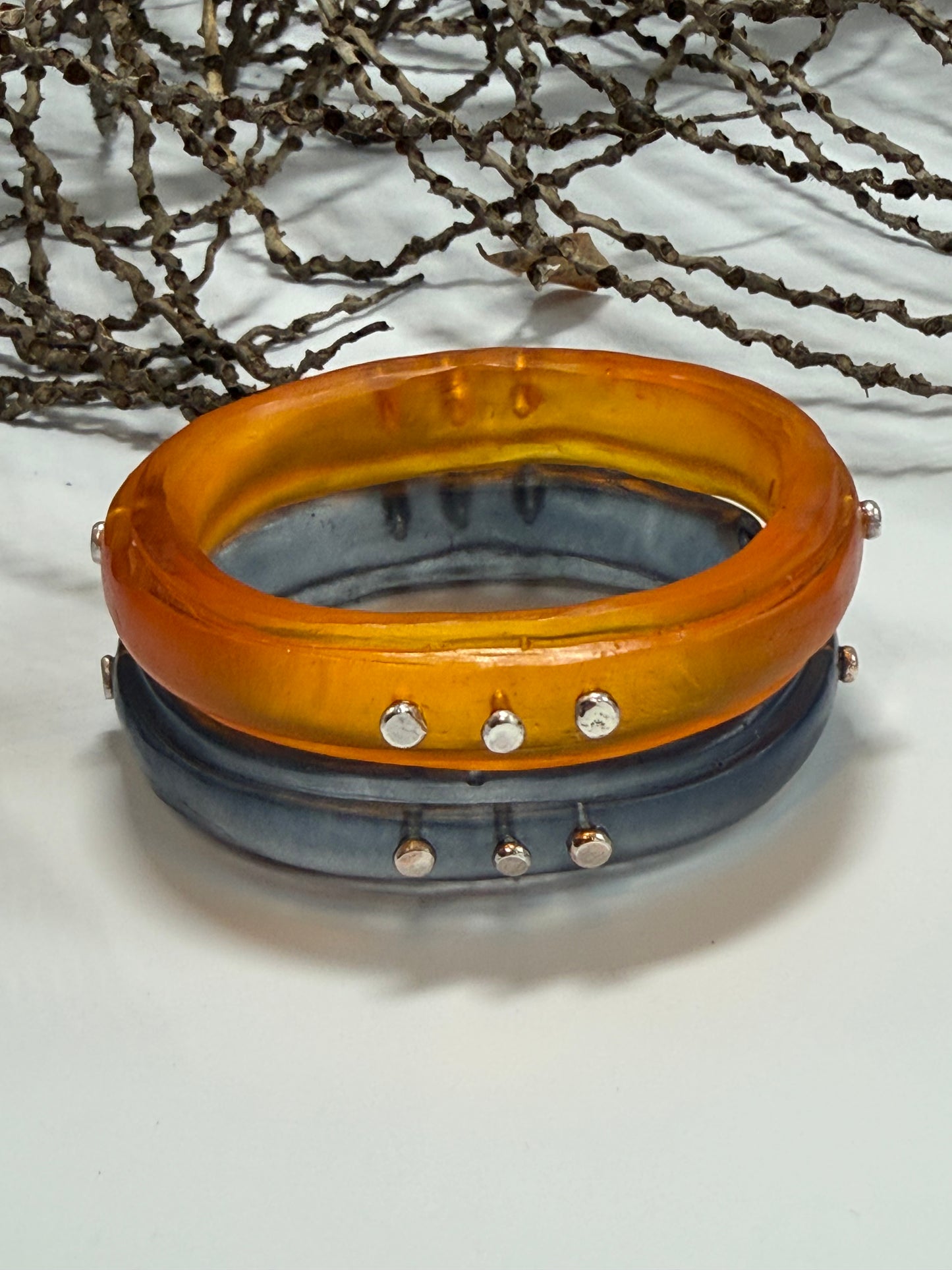 Translucent Burnt Orange resin rim bangle with sterling silver rivets