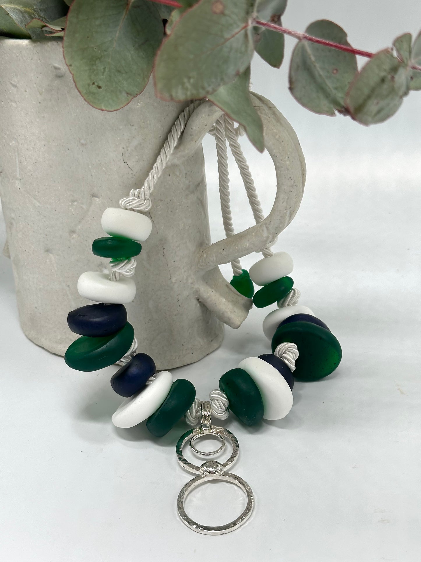 Navy, Green & white resin beads with silver circle pendant