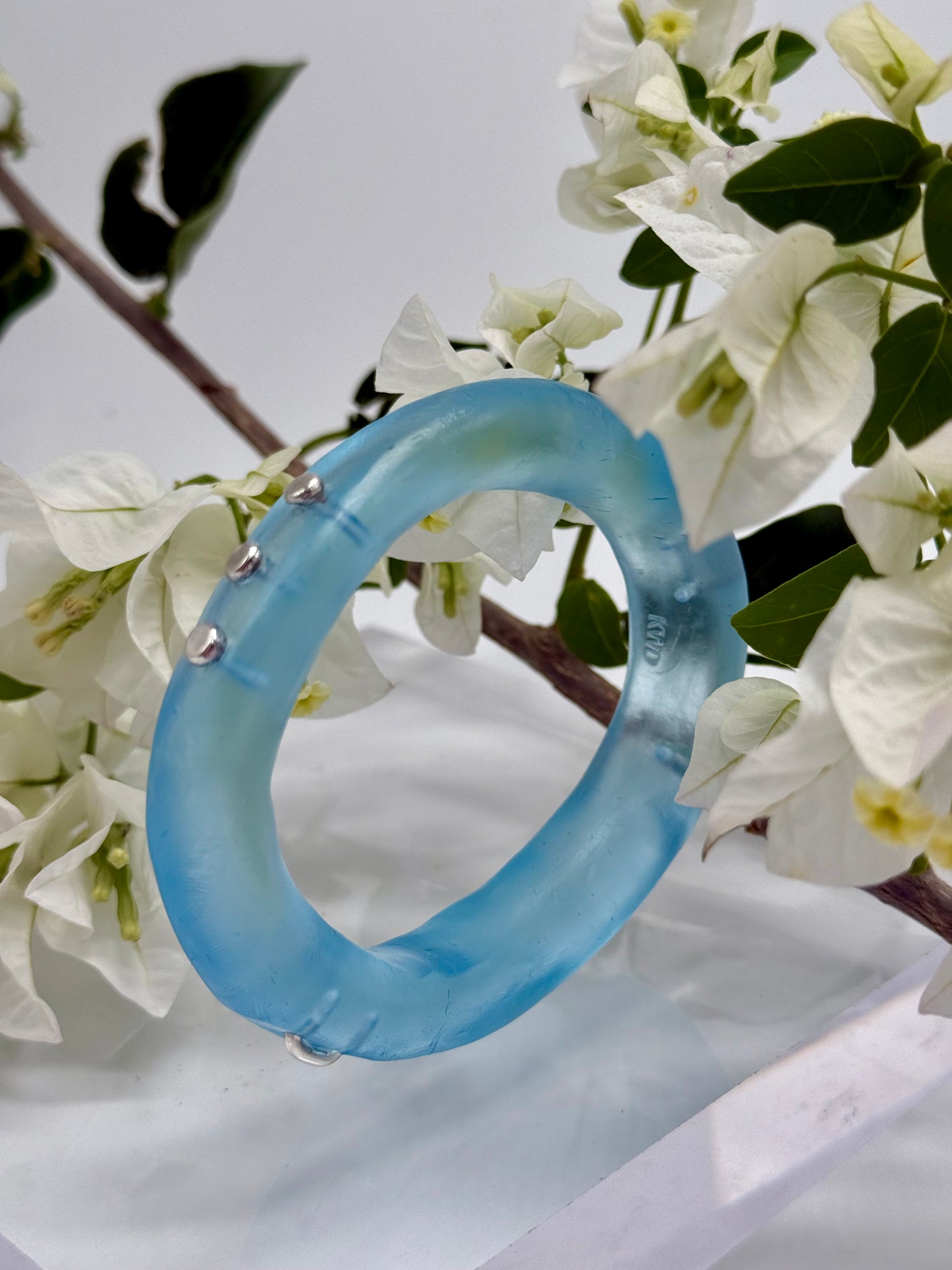 Translucent blue  resin and silver 'woopy' bangle - regular size