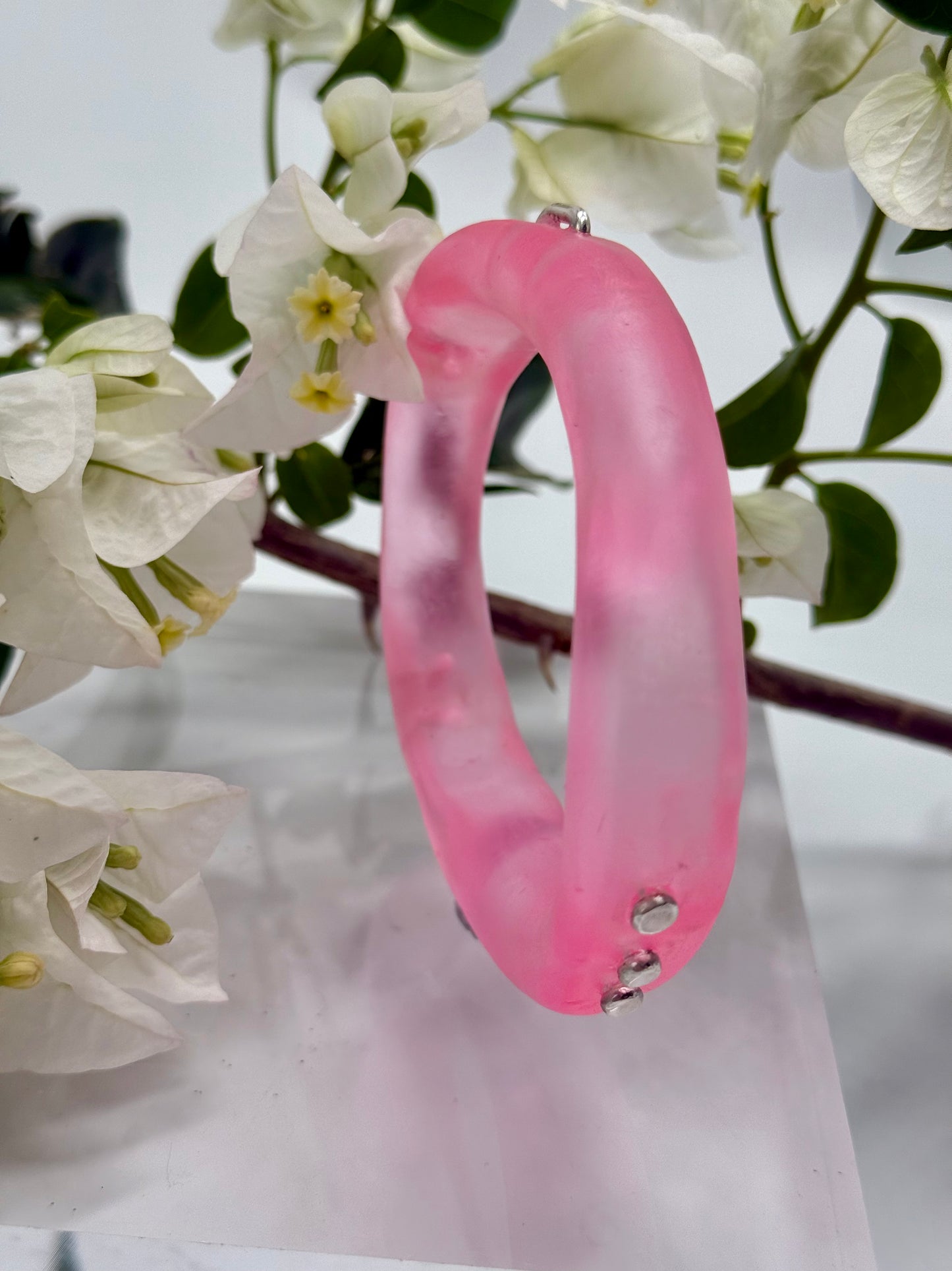 Translucent pink resin and silver 'woopy' bangle - regular size