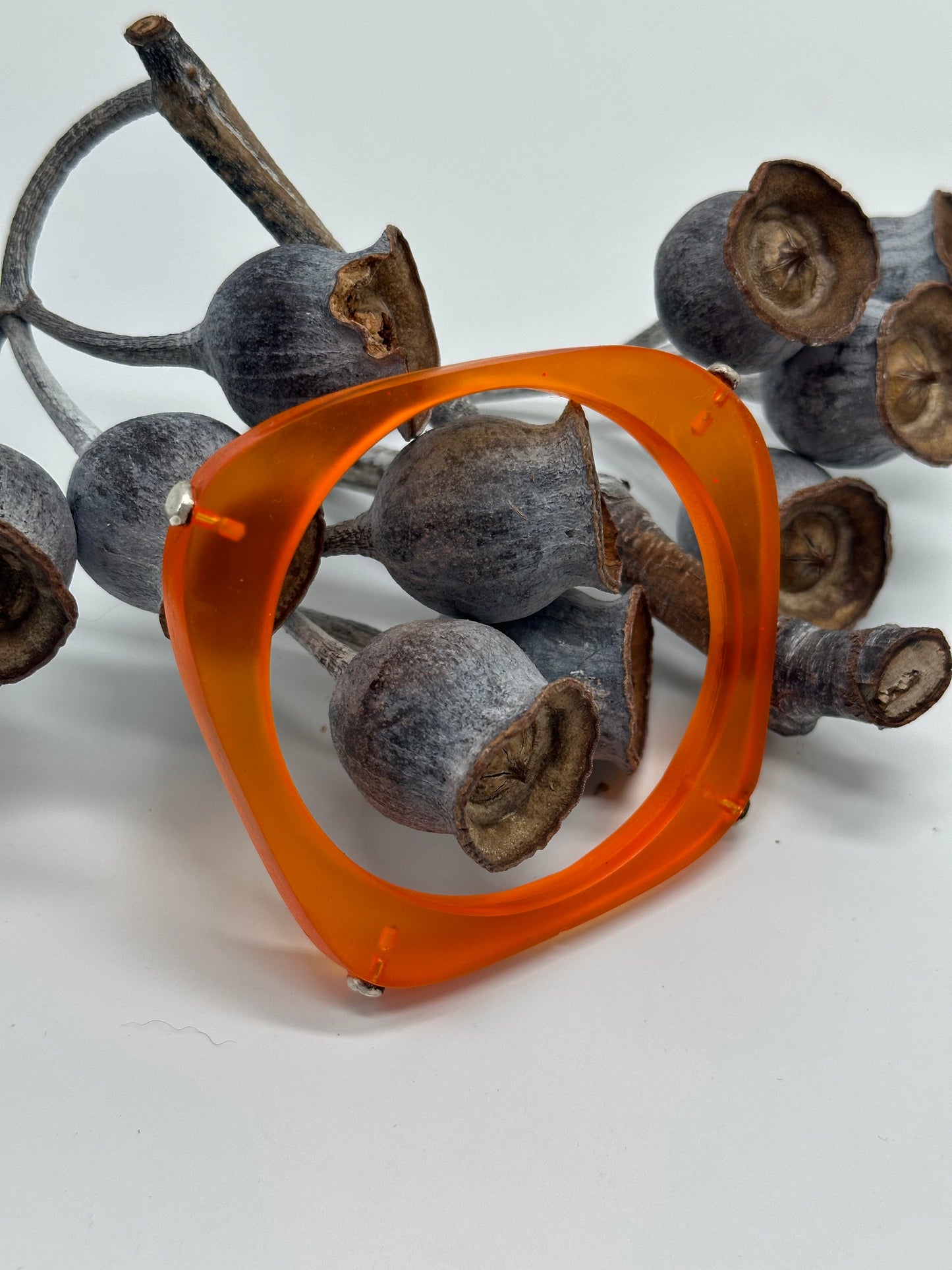 Orange 'square round' bangle with silver